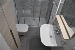 bathroom with shower and washing machine